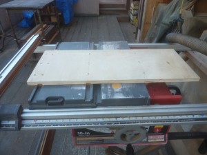 Ed's Sled with runners and side sponsons that allow the sled to be moved back and forth athwart the table saw.