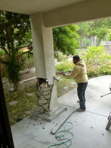 Marcos here demonstrates an early attempt to use the grinder to cut off the stucco - and this is the EASY part.