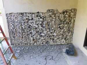 A 25 pound percussion hammer effectively scrags - at waist height and below - the stucco matrix.  And this is the EASY section.