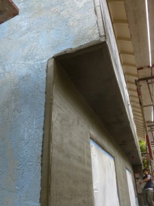 The left shows the original stucco, the right the newly applied glop - that blue glim is an adhesive.