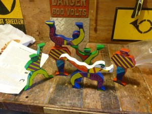 The Hoopla Troupe perform on the workbench and call out for a display cabinet.