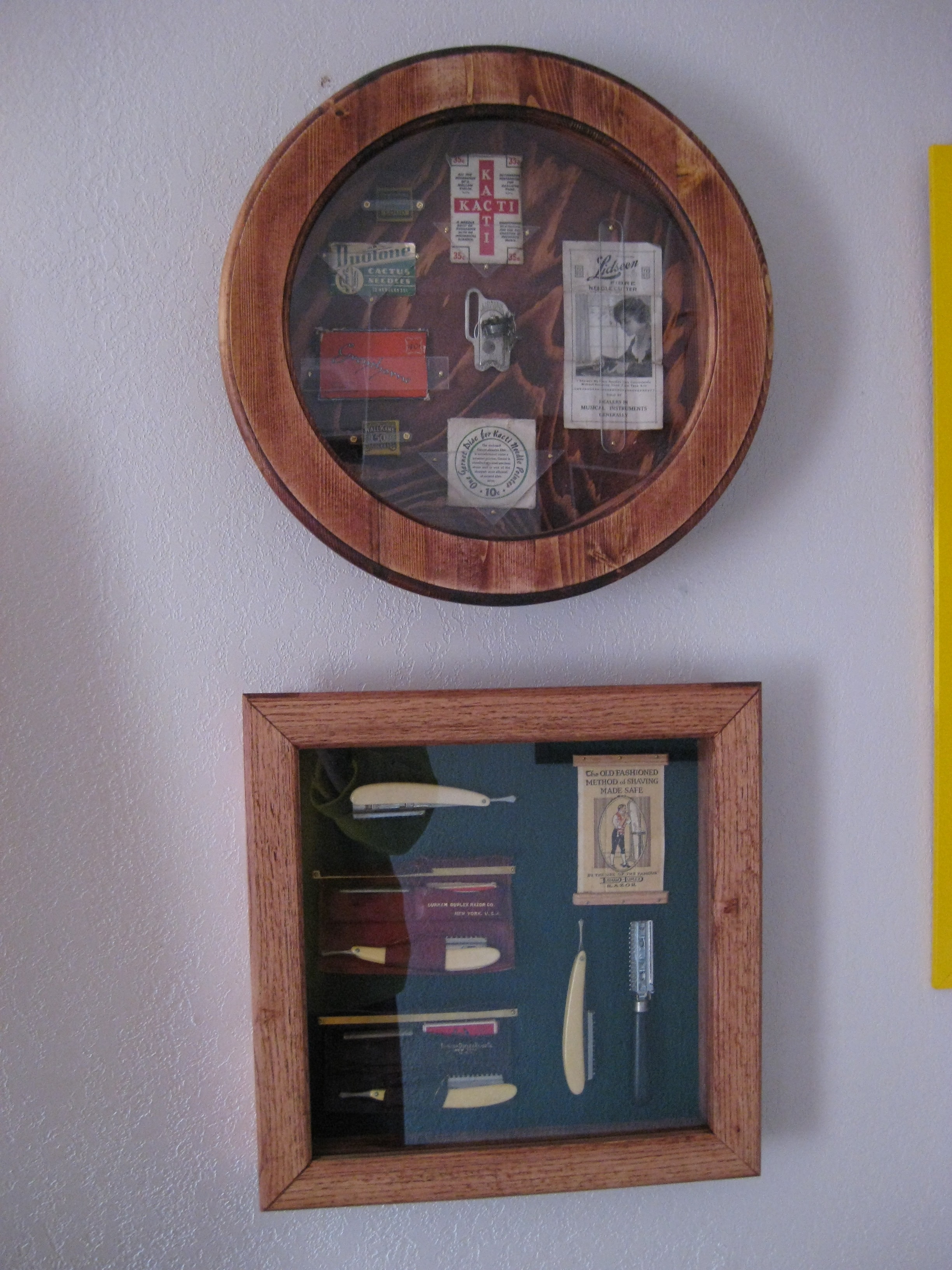 Two display cases built to house early 20th Century razors and wind up phonograph items
